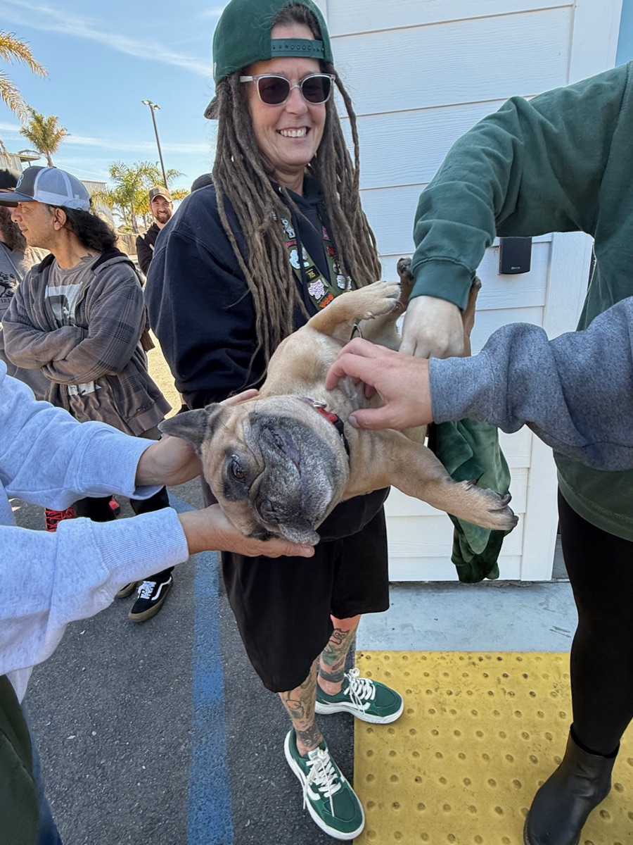 Customer with dog outside SLO CAL Roots